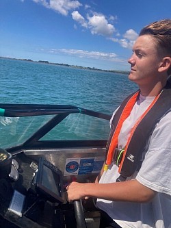 Sam from Tauranga learning the ropes, rules of the road, navigation and close-quarter handling.  He's a natural boatie!